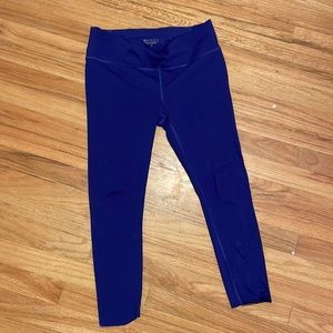 Purple Athleta tights with laser cut details